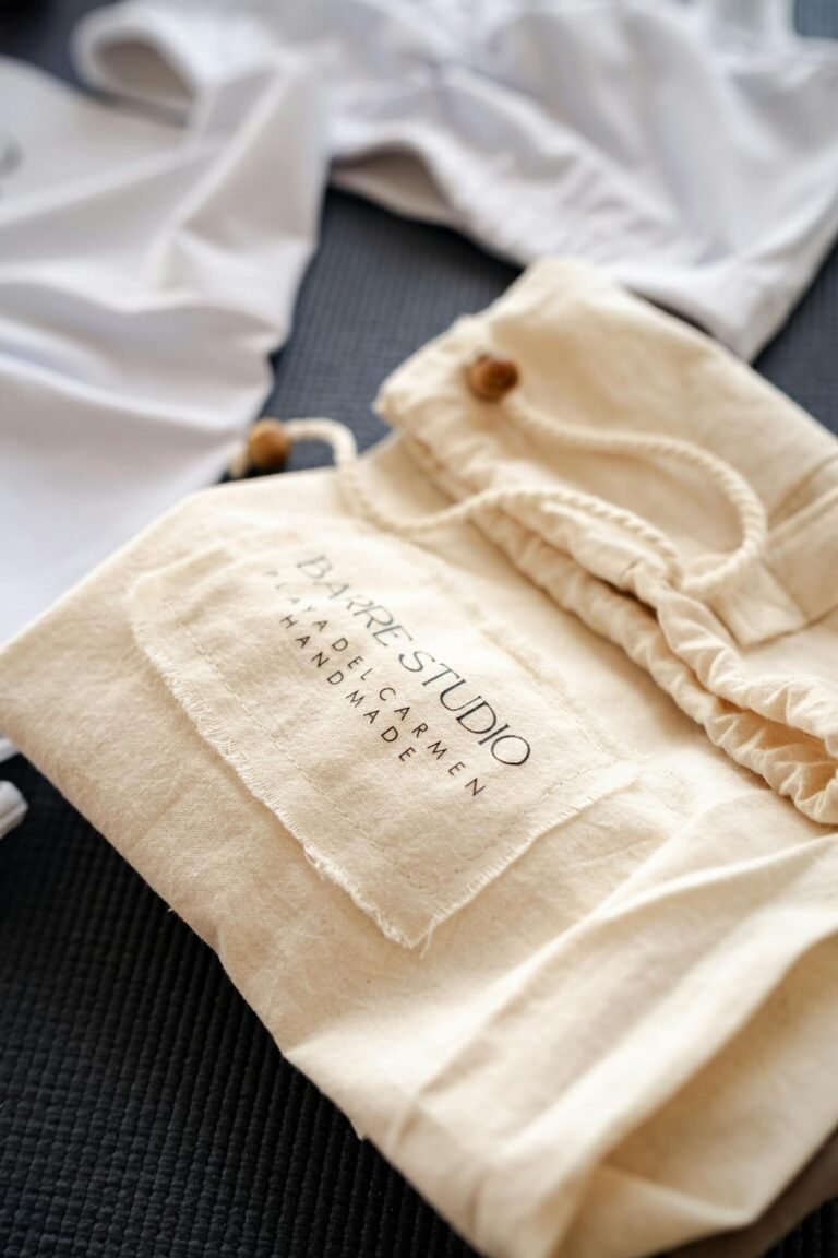 Close-up of a handmade fabric bag with label on a textile surface, showcasing craftsmanship.